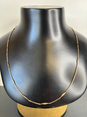a close up of a mannequin with a necklace on it