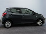 a picture of a small black car parked in a garage