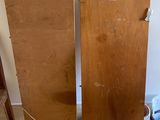 two pieces of wood sitting on the floor next to a chair