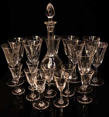 a lot of wine glasses and a decanter on the table