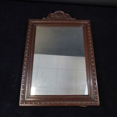 a mirror that is sitting on a black surface