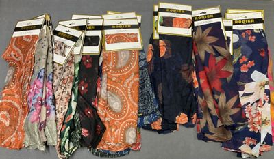 many different types of scarves on display in a store