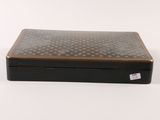 a black box with a pattern on it on a white surface