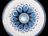 a blue and white plate with a flower design on it