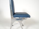 a metal chair with a blue seat on wheels