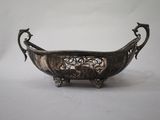an antique silver plated bowl with two birds on it