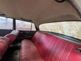 two red seats in the back of a car