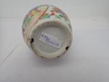 a close up of a vase with a tag on it