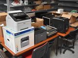 a lot of office supplies on the desk in the room