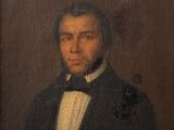 portrait of a man in a tuxedo in a black suit and bow tie