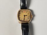 an image of a close up of a wrist watch on a white surface