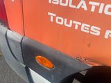 an orange and white truck parked on the side of the road