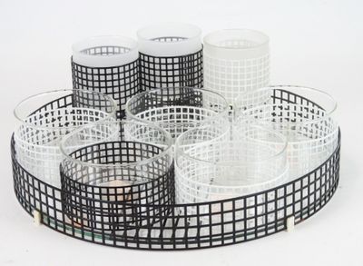 a tray with glasses and cups on it on a white surface