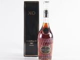 an old bottle of rum in front of a black box