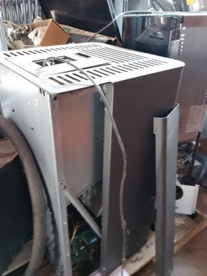 a microwave oven sitting on top of a pile of junk