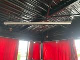 a room with red curtains and a ceiling fan in it