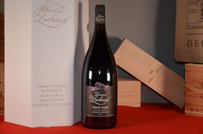 a bottle of wine sitting on a table next to a box
