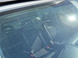 a broken windshield of a car with a bike on it