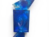 a close up of a blue glass object on a white surface