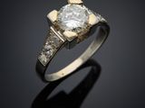 une bague en diamant et en or posée sur un fond noir