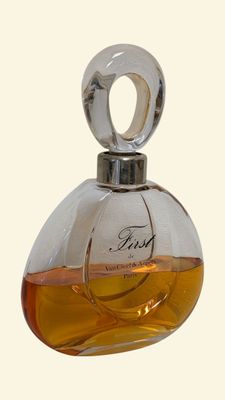 a small bottle of perfume on a white surface