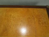 a wooden table with writing on the top of it