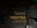 the back of a pair of black and green shoes with a gold firepro logo