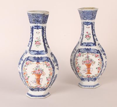 pair of blue and white vases with floral designs on them