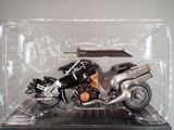a toy motorcycle in a plastic case on a table