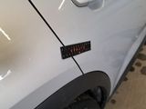 a sticker on the side of a white car
