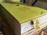 a large stack of books sitting on a pallet in a warehouse