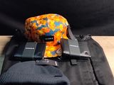 a black bag with a camera and a cell phone on it