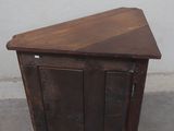 a small wooden cabinet with a door on top of it