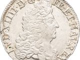 a silver coin with a woman ' s head and a crown on it