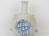 a white vase with a blue design on it