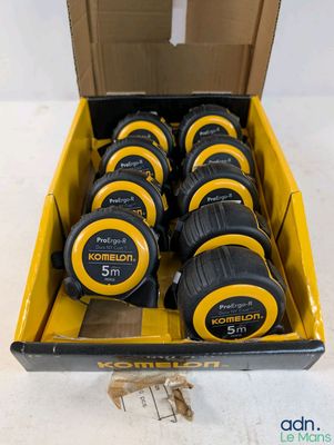 a box full of measuring tape in a cardboard box on a table