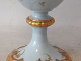 a blue and gold vase sitting on a table