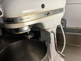 a mixer that is sitting on the counter in the kitchen