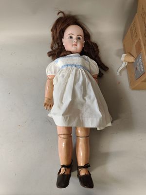 a doll that is laying on the floor next to a box