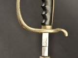 a close up of a sword with a face on it