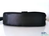 a black belt that is sitting on a white table