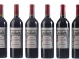 six bottles of red wine are lined up in a row