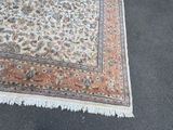a rug on the ground with a cat laying on it