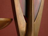 a sculpture of a bird sitting on top of a bowl