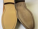 a close up of a pair of shoes with a box in the background