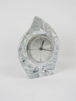 a small crystal clock sitting on a white surface