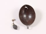 a small wooden object with a metal object on it