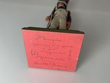 a figurine of a soldier with a note on it