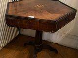 a small table with a wooden top on a hard wood floor
