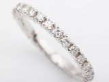 a close up of a diamond ring on a white background